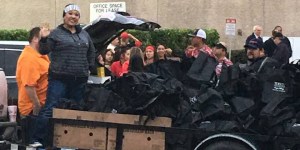 Grupo Imagen's Silvia Navarro poses with frozen turkeys at Majic 95.9's annual Turkey Drive. (Facebook photo)
