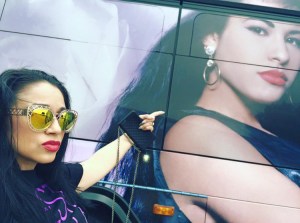 Barbi Leo from Tejano Nation affiliate KSAB-FM in Corpus Christi points to the new Selena-themed buses on Monday, April 18. (Facebook)